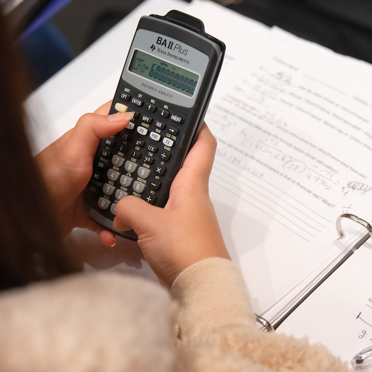Student holding calculator