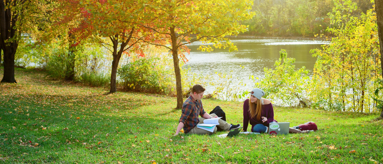 Students sitting by river