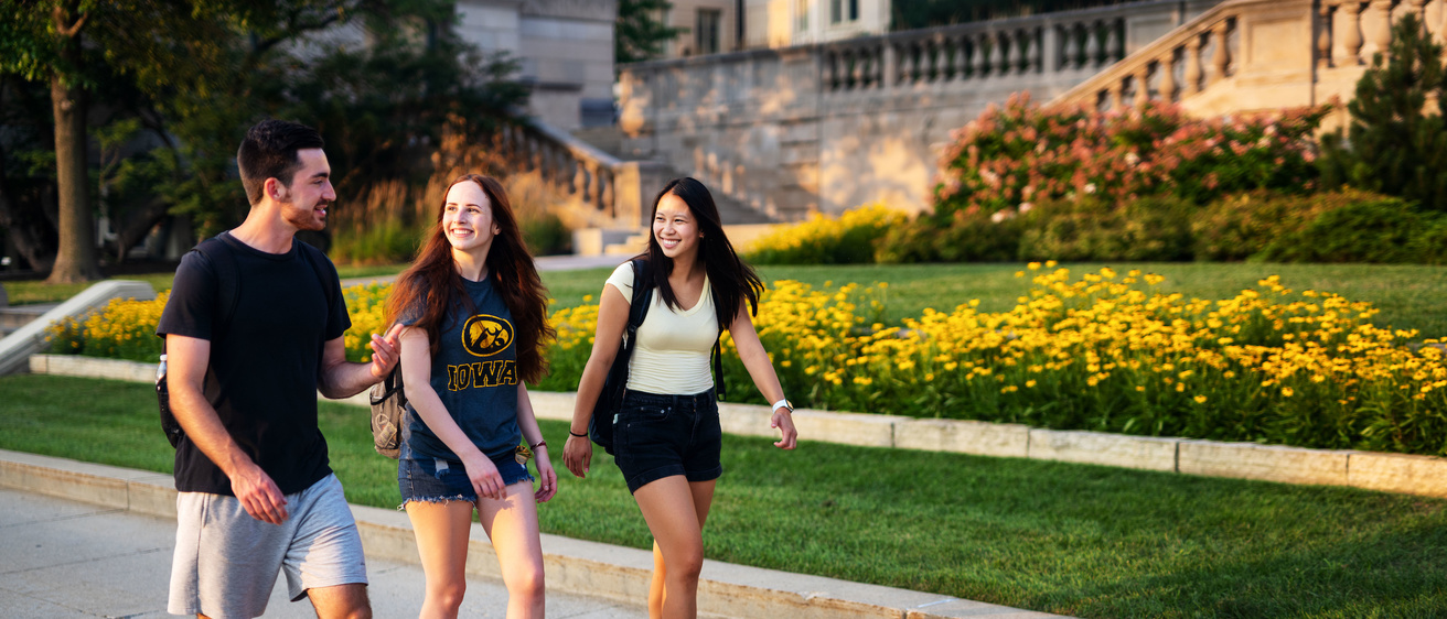 students walking behind old cap