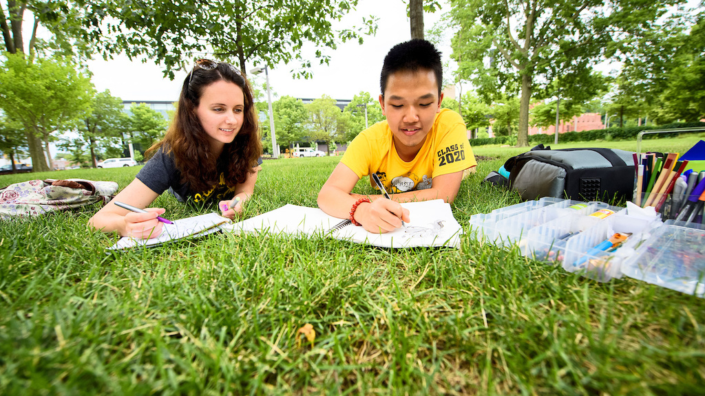 two students studying on the pentacrest