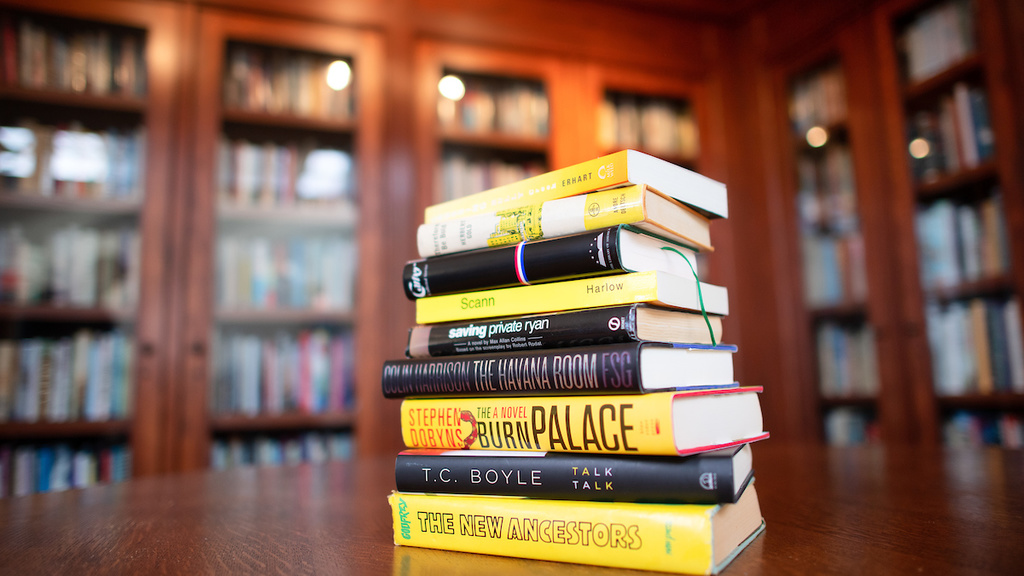Stack of books alternating in spine colors from gold to black