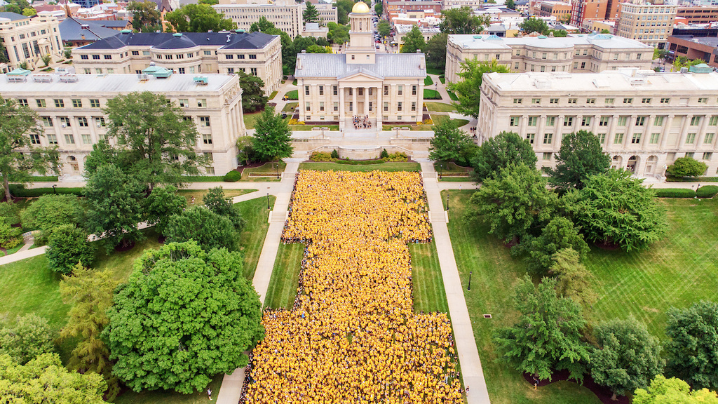 Students clustered in a "Block I" as a symbol of Iowa in front of the Old Capitol Building.