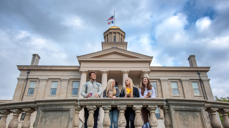 Students standing behind old capitol